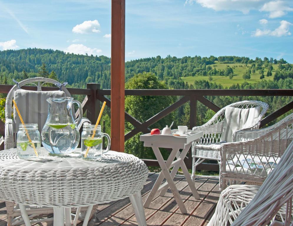 a table and chairs on a deck with a view at Sarnówka KDN in Rajcza
