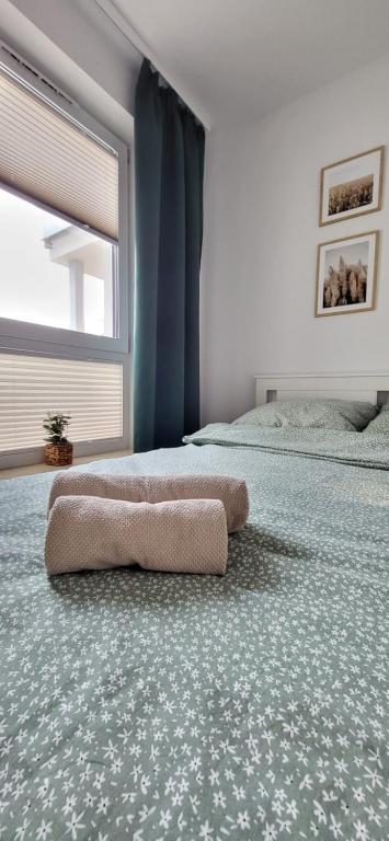 a room with two beds with a pillow on the floor at Apartament 6 Premium Taras Parking Centrum in Gołdap