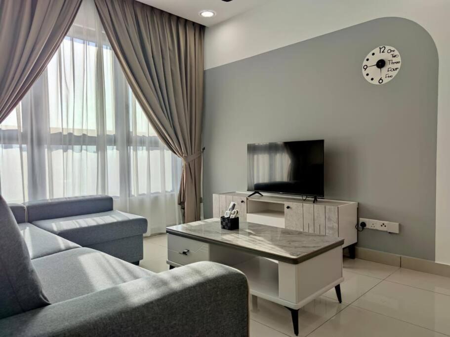 a living room with a couch and a table and a tv at M Vertica kl 3r2b 7 pax cosy house 3min mrt, sunway velocity mall, 8min ikea in Kuala Lumpur
