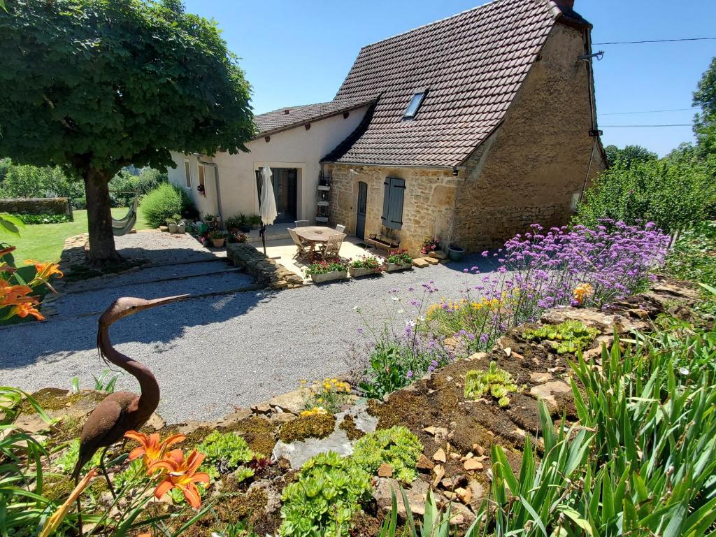 a garden with a bird in front of a house at Le Pech de Vigne in Bio