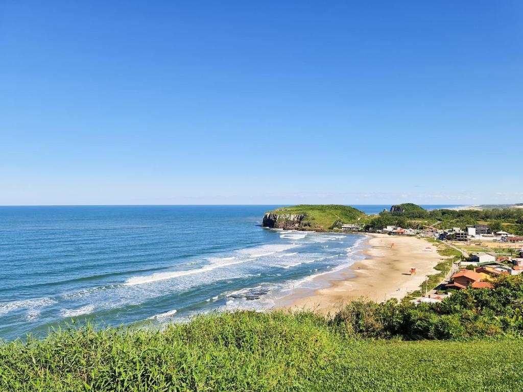 a view of a beach with the ocean at Hotel Ficare Torres in Torres