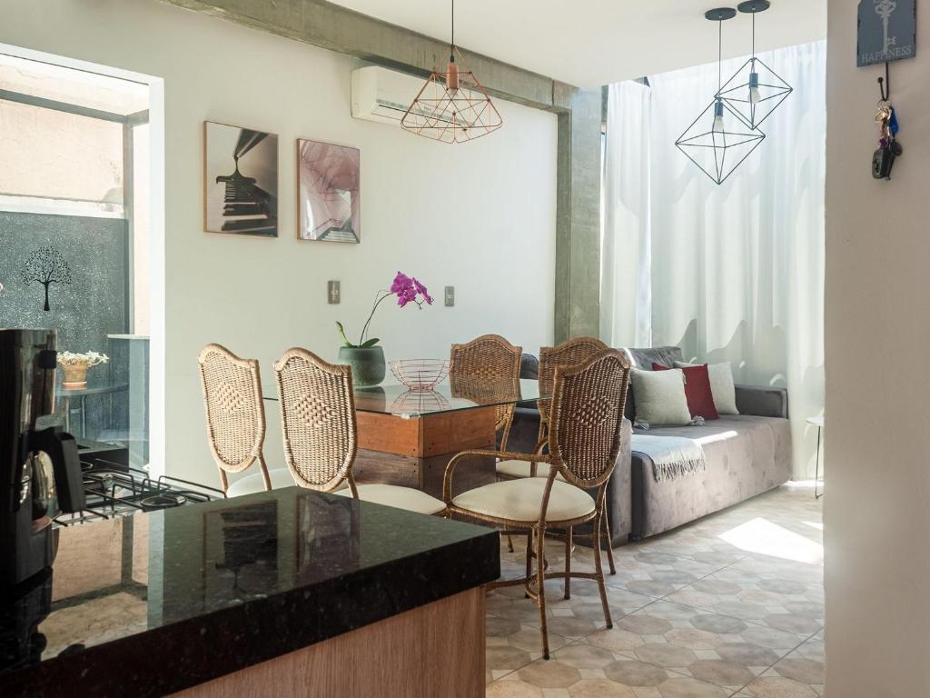 a living room with a couch and a table and chairs at Residencial Aroeira in Balneário Camboriú