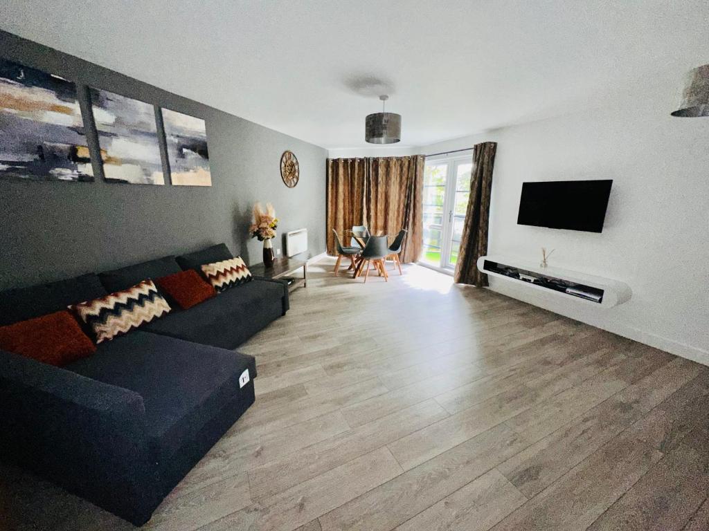 a living room with a couch and a tv at Luxury Apartments - Wallis Square, Farnborough in Farnborough