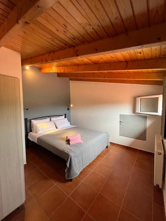 a bedroom with a bed and a wooden ceiling at Ενθύμιον in Nafplio