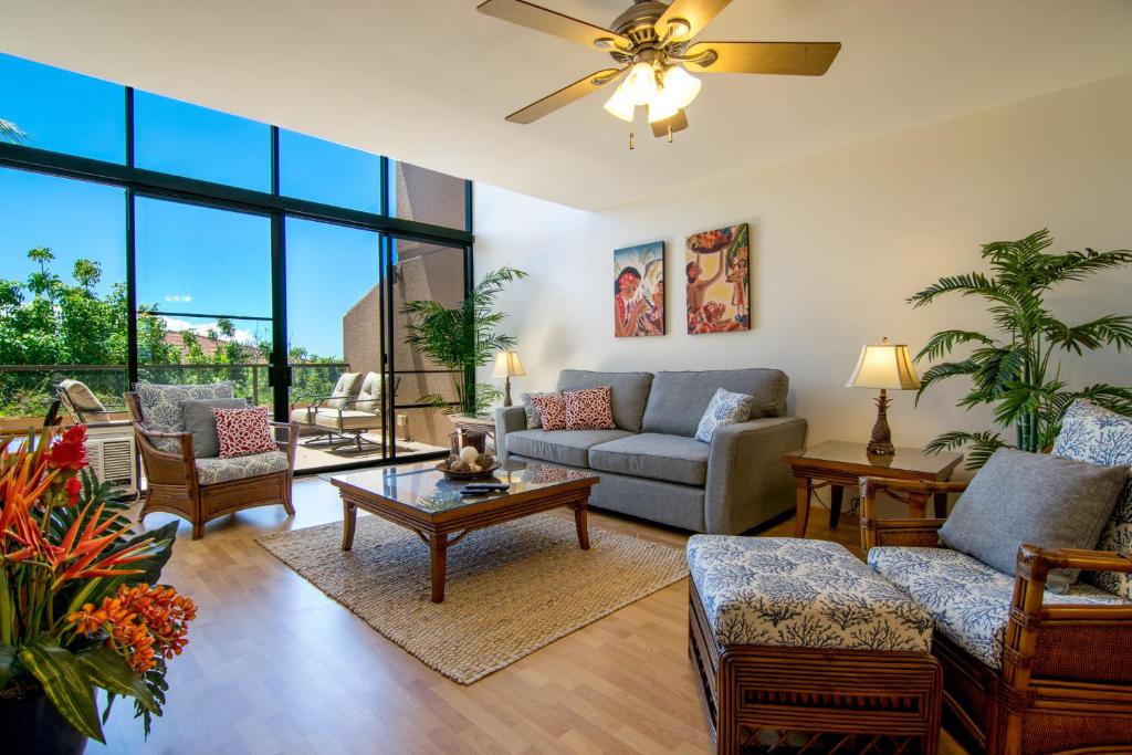 a living room with a couch and a table at Kahana Villa E409 in Kahana
