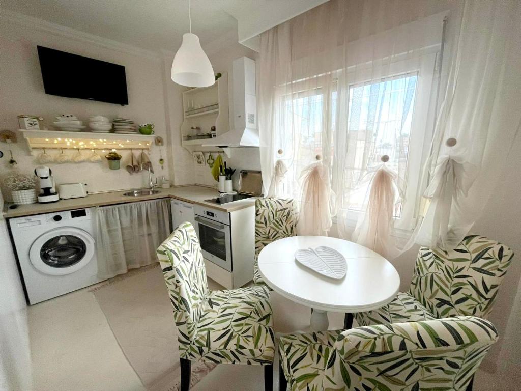 a kitchen with a table and two chairs and a table at White House Kavala in Kavála