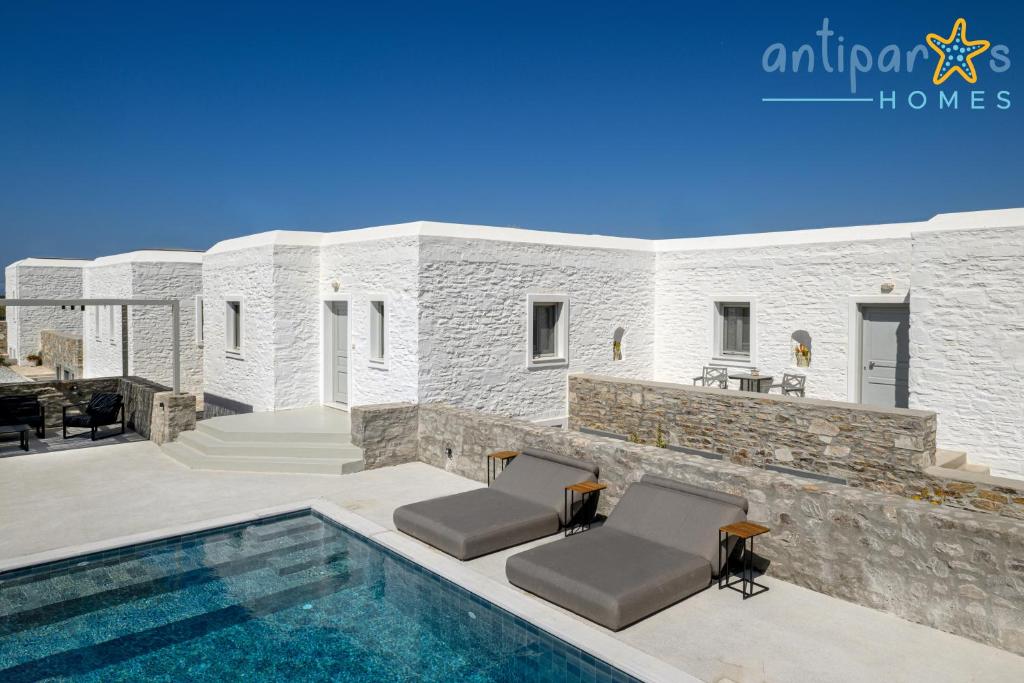 a villa with a swimming pool and a house at Antiparos Homes in Antiparos
