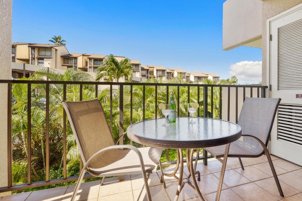 a patio with a table and chairs on a balcony at Kamaole Sands 8-201 in Wailea