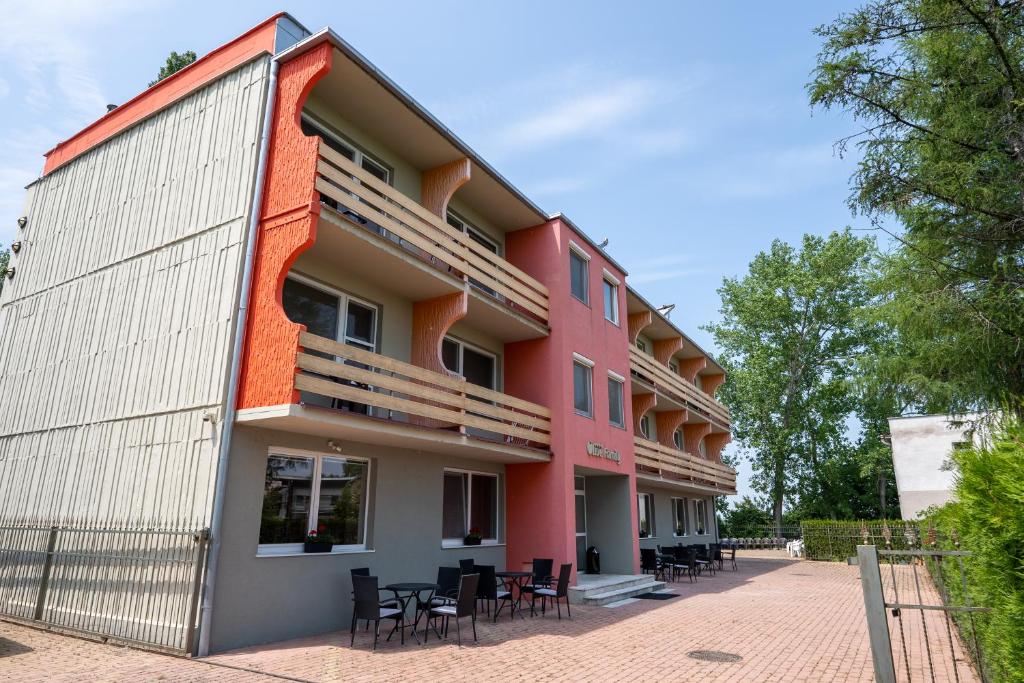 a building with tables and chairs outside of it at Rekreačné zariadenie Oliva - Patince in Patince