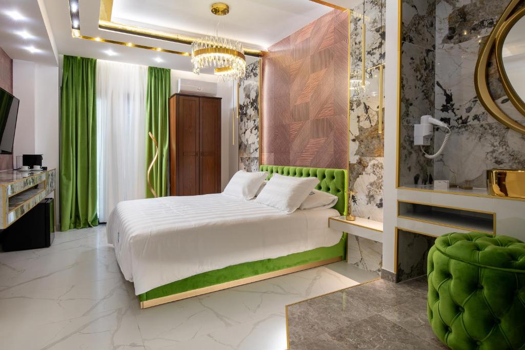 a bedroom with a white bed and green curtains at Pela Veranda Exquisite Suites in Neos Marmaras