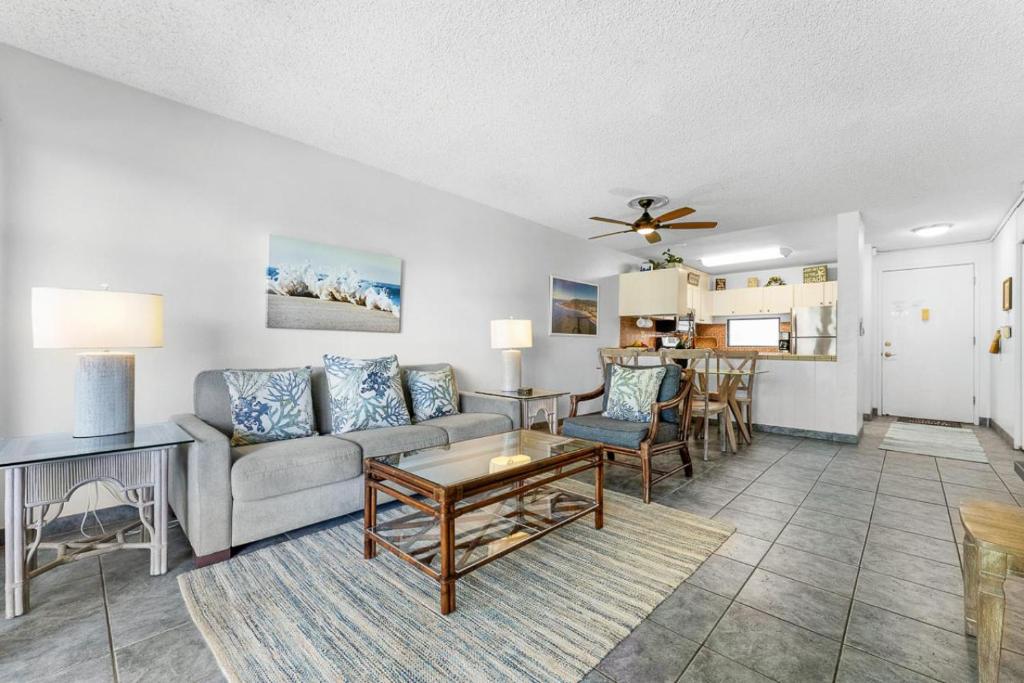 a living room with a couch and a table at Kihei Akahi B102 in Wailea