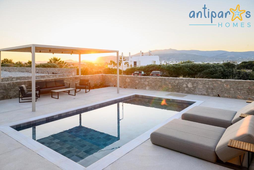 a villa with a swimming pool and a patio at Antiparos Homes in Antiparos