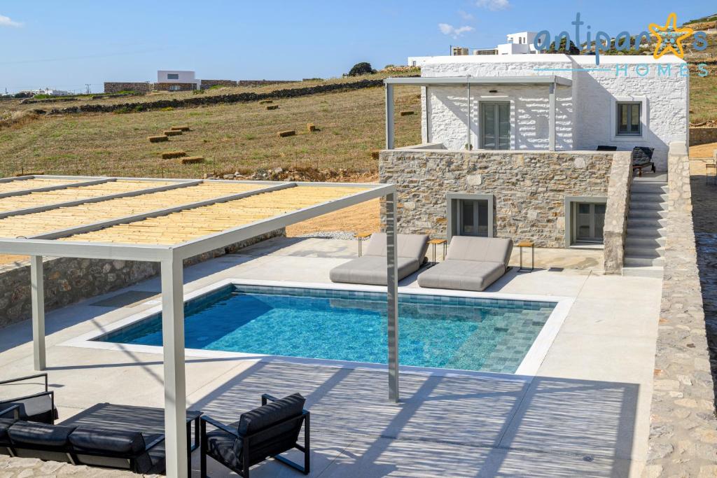 a villa with a swimming pool and a house at Antiparos Homes in Antiparos