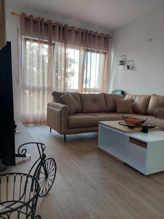 a living room with a couch and a coffee table at Gex apartments in Tirana
