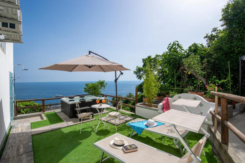 a patio with a table and an umbrella at Rays of sun - apartment in Positano