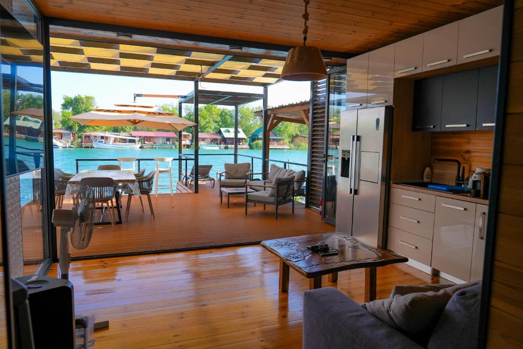 a kitchen and living room with a table and a pool at Pirates Nest Cottages in Ulcinj