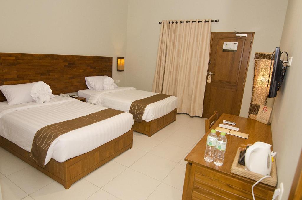 Letto o letti in una camera di Syailendra Hotel Syariah