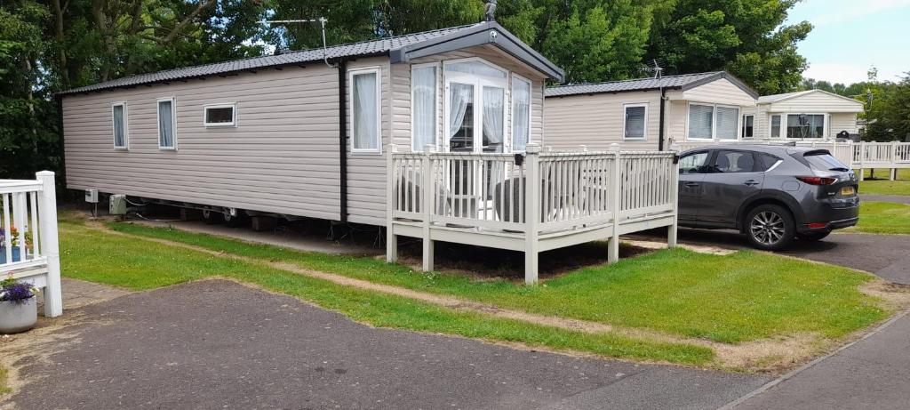 a house with a car parked in front of it at Luxury spacious family caravan in Edinburgh