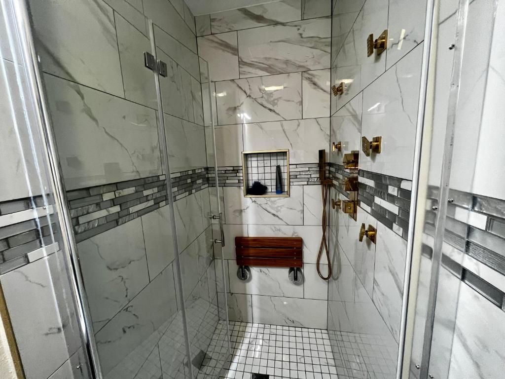 a bathroom with a shower with a glass door at Modern 1 Bedroom Home W/ Sauna & Shower-Jets in Carson