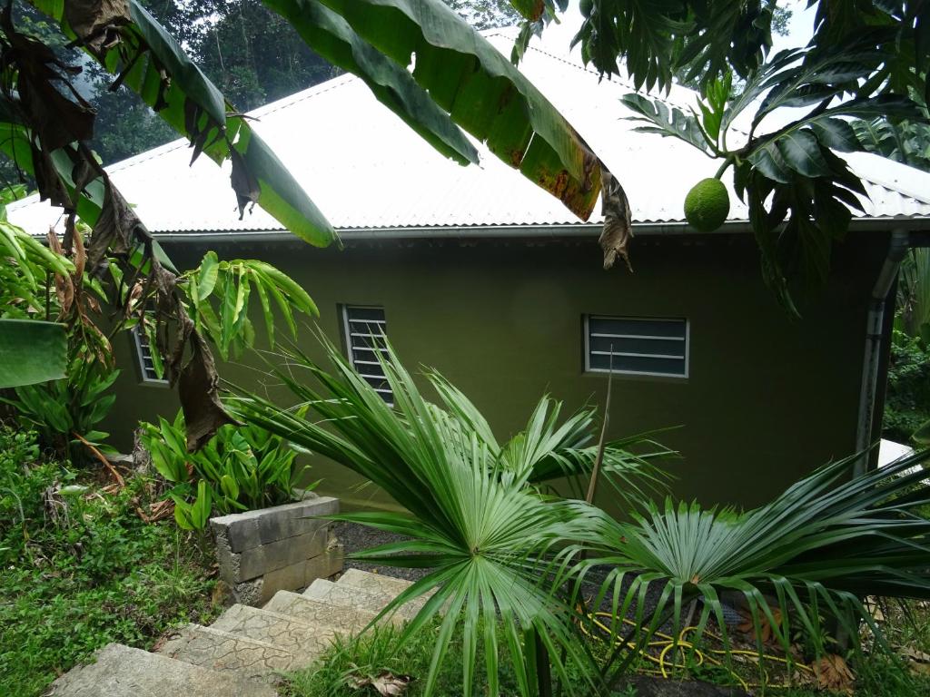 ein Haus inmitten eines Gartens in der Unterkunft Bungalow DOUROU in Deshaies