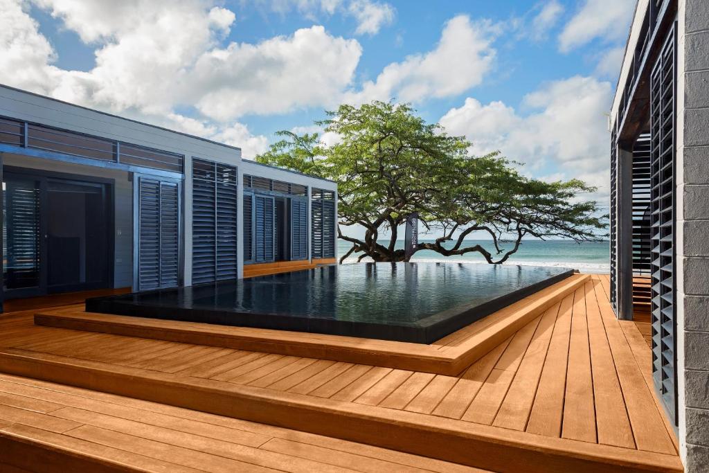 a swimming pool on the deck of a house at 99 Surf Lodge in El Limón