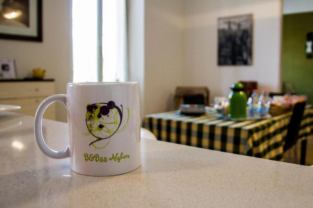 a coffee cup sitting on a counter with a table at B&B 55 Alghero in Alghero