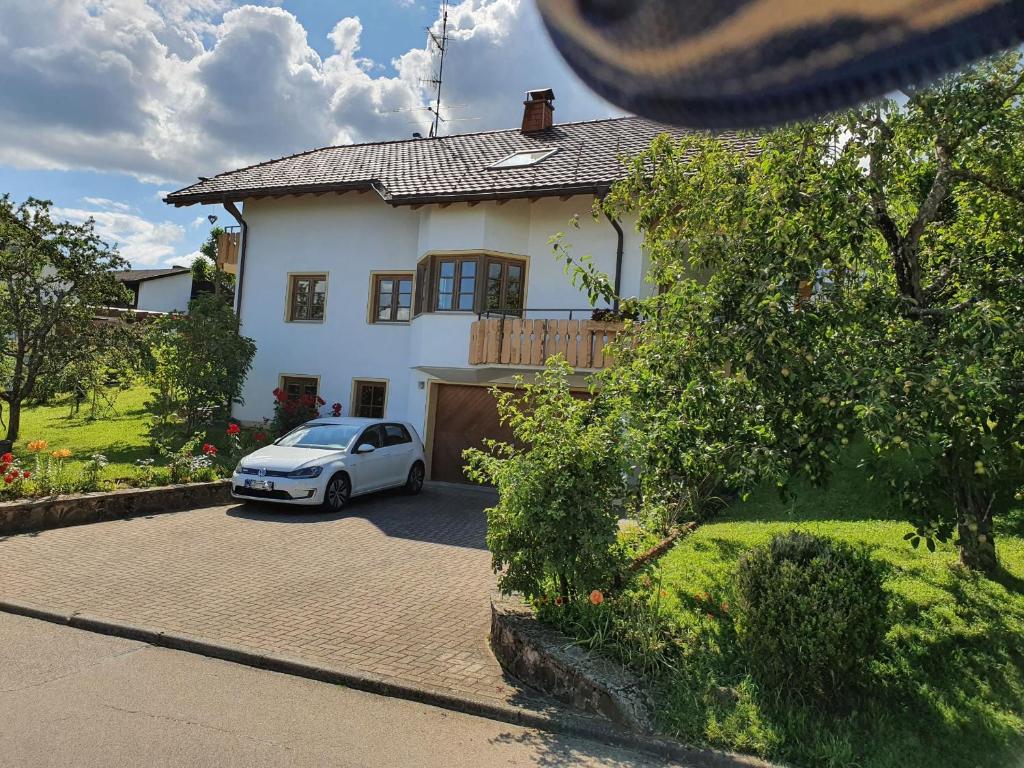a white car parked in front of a house at Haus Sonnenblume in Weilheim