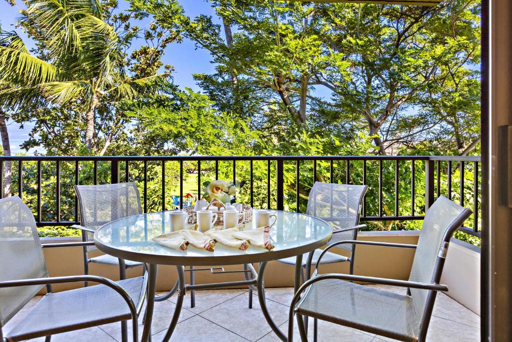 a patio with a table and chairs on a balcony at Paki Maui 326 in Kahana