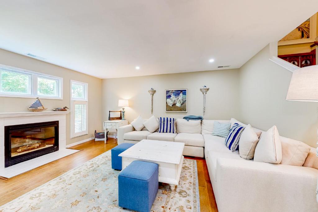 a living room with white furniture and a fireplace at Sea Colony --- 38924 Cypress Lake Circle Unit 56079 in Bethany Beach