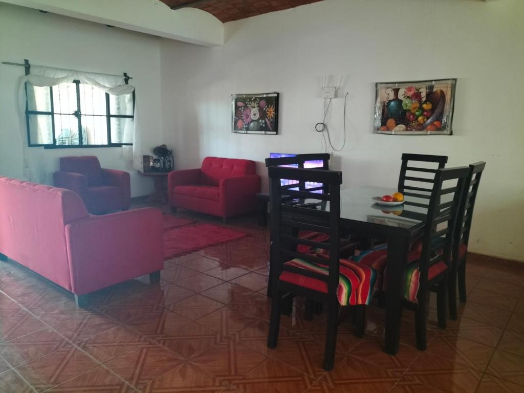 a living room with a table and chairs and a couch at Casa las cabras in La Peñita de Jaltemba