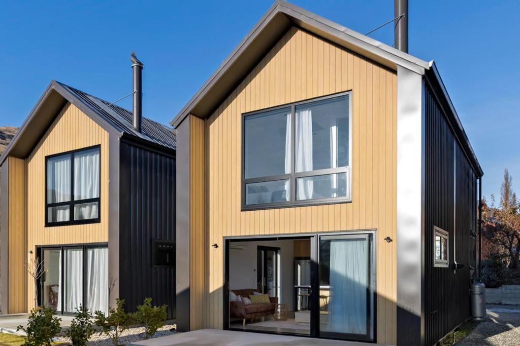 a house with black and orange at Cardrona Vista Apartment in Cardrona