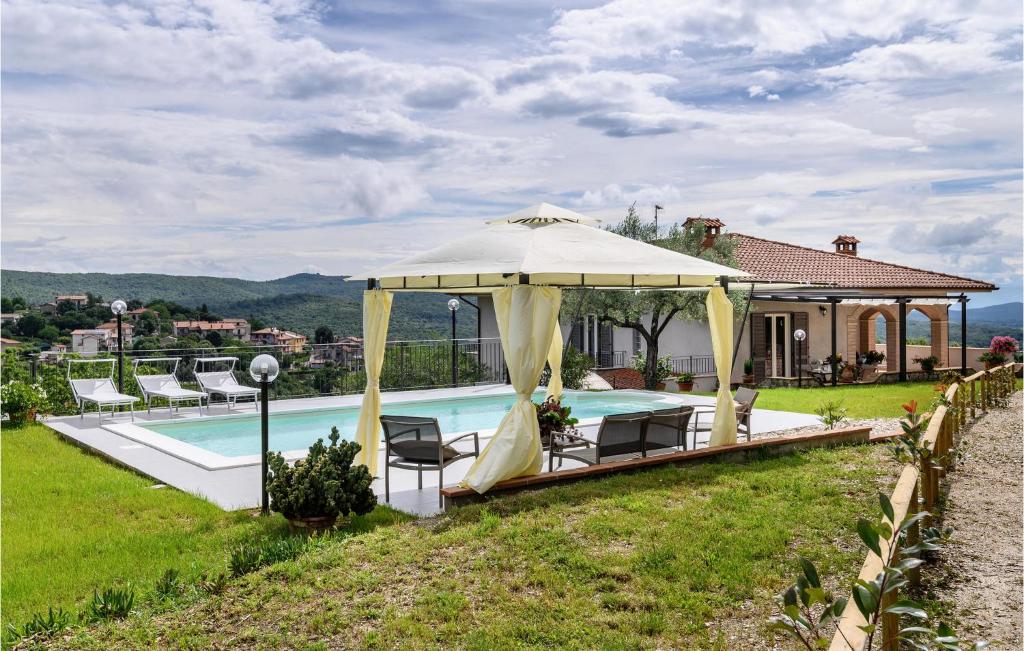 a house with a swimming pool and a gazebo at Lovely Home In Amelia With Kitchen in Amelia
