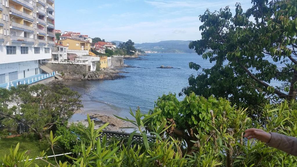 a view of the ocean from a building at Apartamento Carabuxeira 1 in Sanxenxo