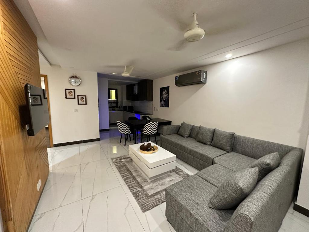 a living room with a couch and a table at 2 Bed Apartment near Gulberg in Lahore