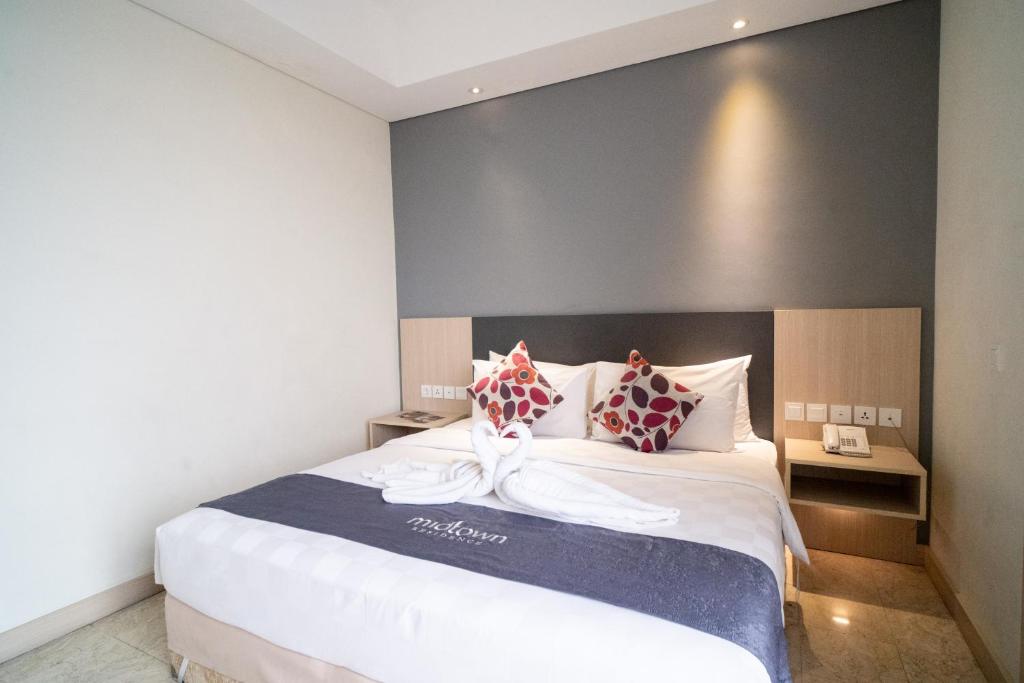Postel nebo postele na pokoji v ubytování Midtown Residence Simatupang Jakarta