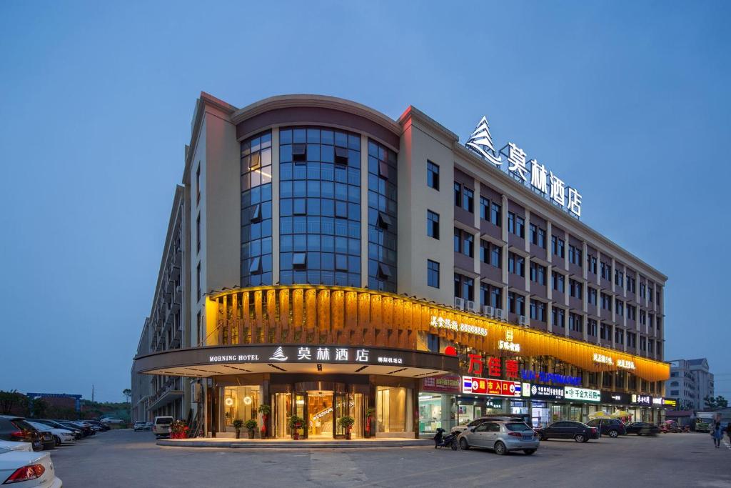 a building on a street with cars parked in front of it at Morning Hotel, Changsha Langli in Changsha