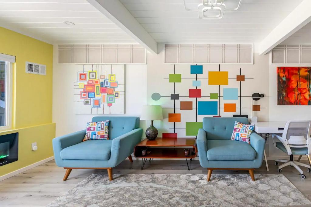 two blue chairs in a living room with a colorful wall at Private Luxury Retreat with Kitchen Near SF & Wine Country in San Rafael