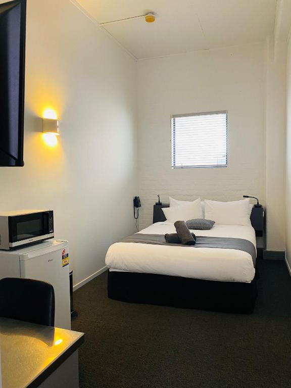 Postel nebo postele na pokoji v ubytování Gamma Hotel