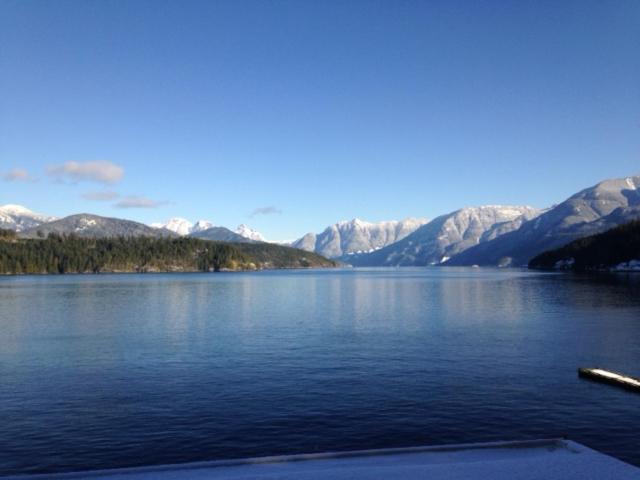 a view of a lake with mountains in the background at Earls Cove Orca View in Egmont