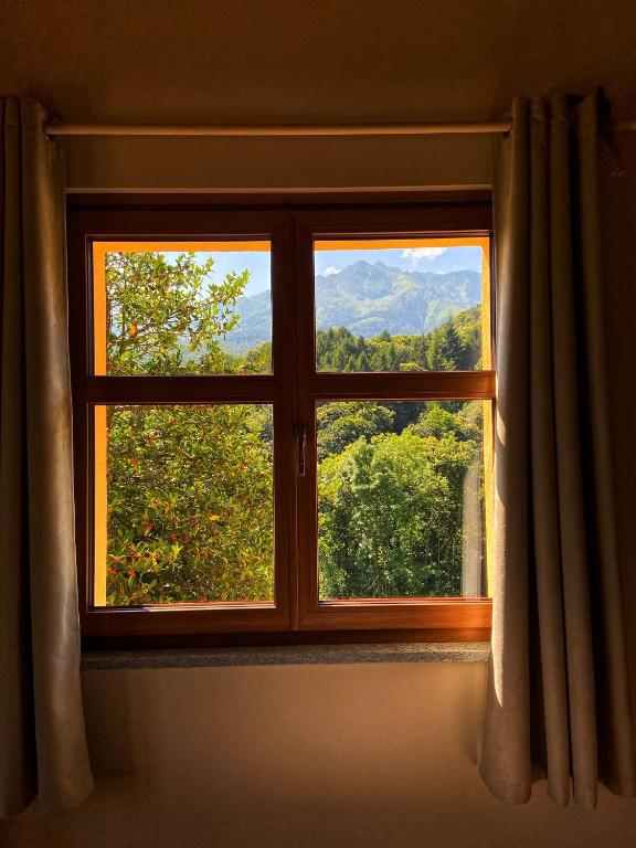 a window with a view of a mountain view at Ranch Enbrucà in Boves