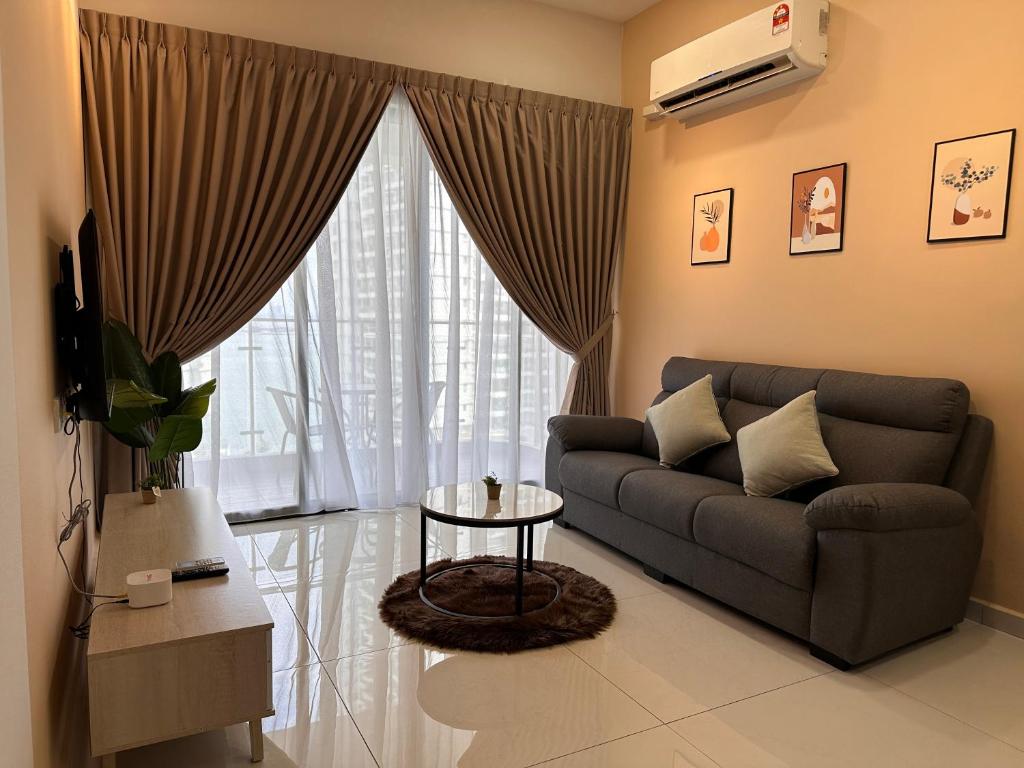 a living room with a couch and a table and a window at Country Garden Cozy 2 Bedroom @ By Hauz Cinta in Johor Bahru