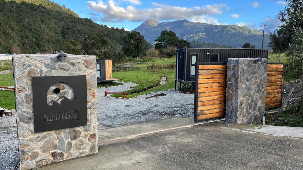 a couple of entrances to a building with mountains in the background at Puerta austral in Puelo