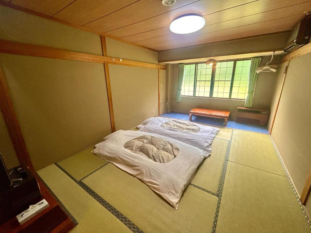 Postel nebo postele na pokoji v ubytování Hakuba Park Hotel