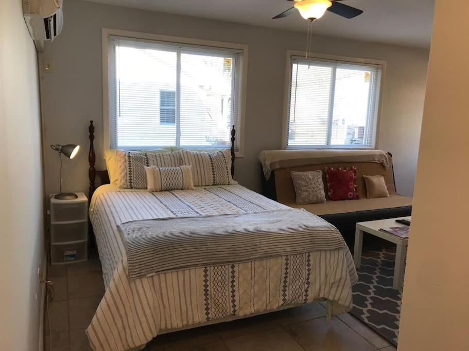 a bedroom with a large bed and two windows at Walk2Metro's,DCGem,Private,Wifi, FreeParking in Arlington