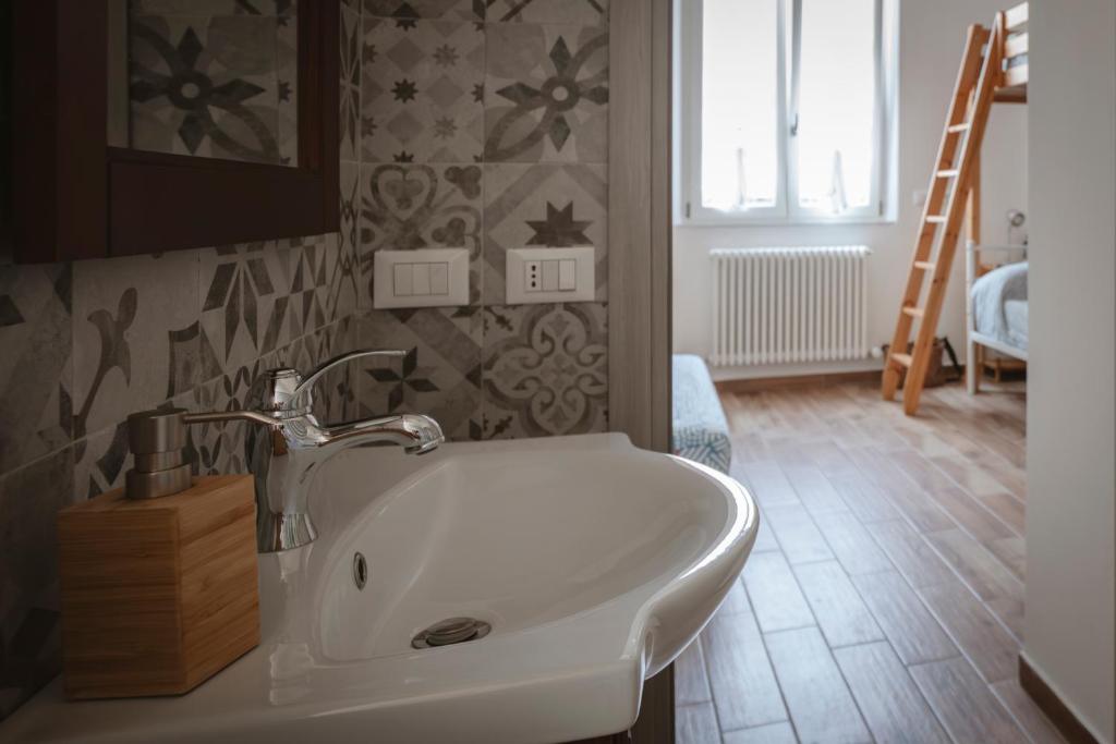 a bathroom with a white sink in a room at Villa Valentina Versilia in Viareggio