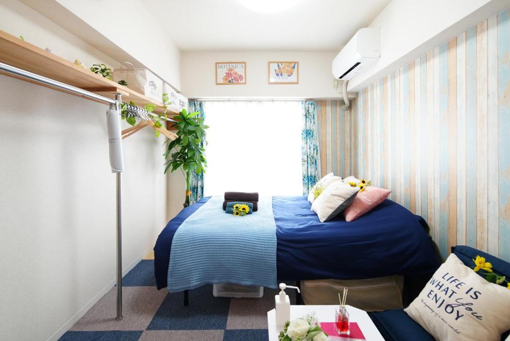 Habitación pequeña con cama y ventana en SC Kameari 1003, en Tokio