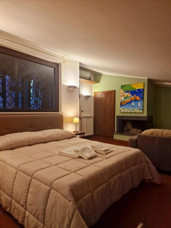a bedroom with a large bed and a fireplace at DOMUS SAN CARLO LOFT in Caserta