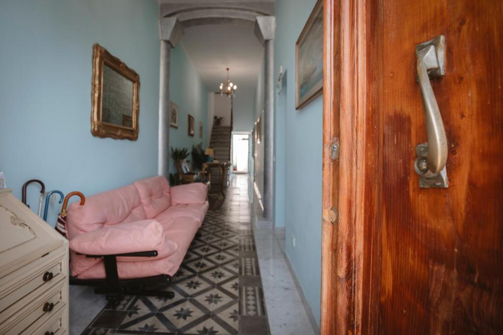 a living room with a pink couch and a hallway at Villa Valentina Versilia in Viareggio