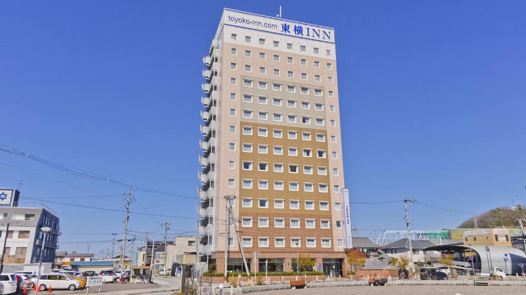 a tall building with a sign on top of it at Toyoko Inn Maibara eki Shinkansen Nishi guchi in Maibara