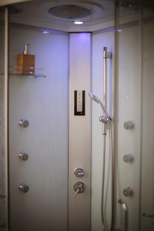 a shower in a bathroom with white walls at Villa Valentina Versilia in Viareggio